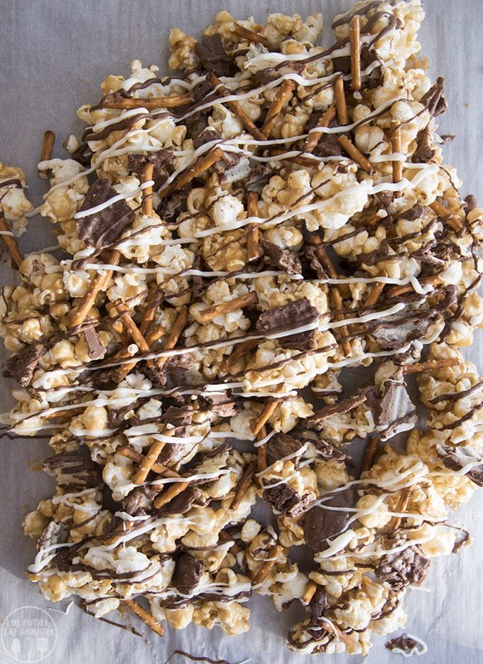 This potato chip and pretzel caramel popcorn is the perfect sweet and salty treat! Gooey caramel popcorn full of salty pretzels, salty and sweet chocolate dipped potato chips and drizzled in more milk and white chocolate!