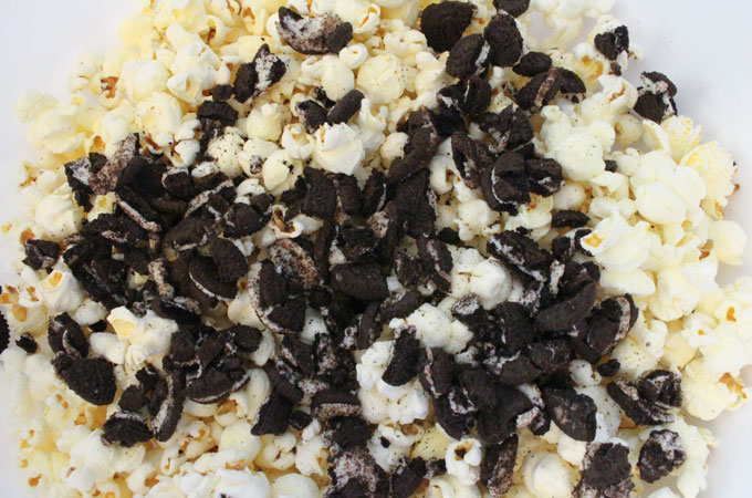 Pour crushed Oreo Cookies into popcorn