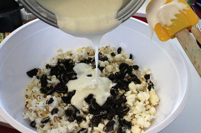 Pour Marshmallow mixture into popcorn